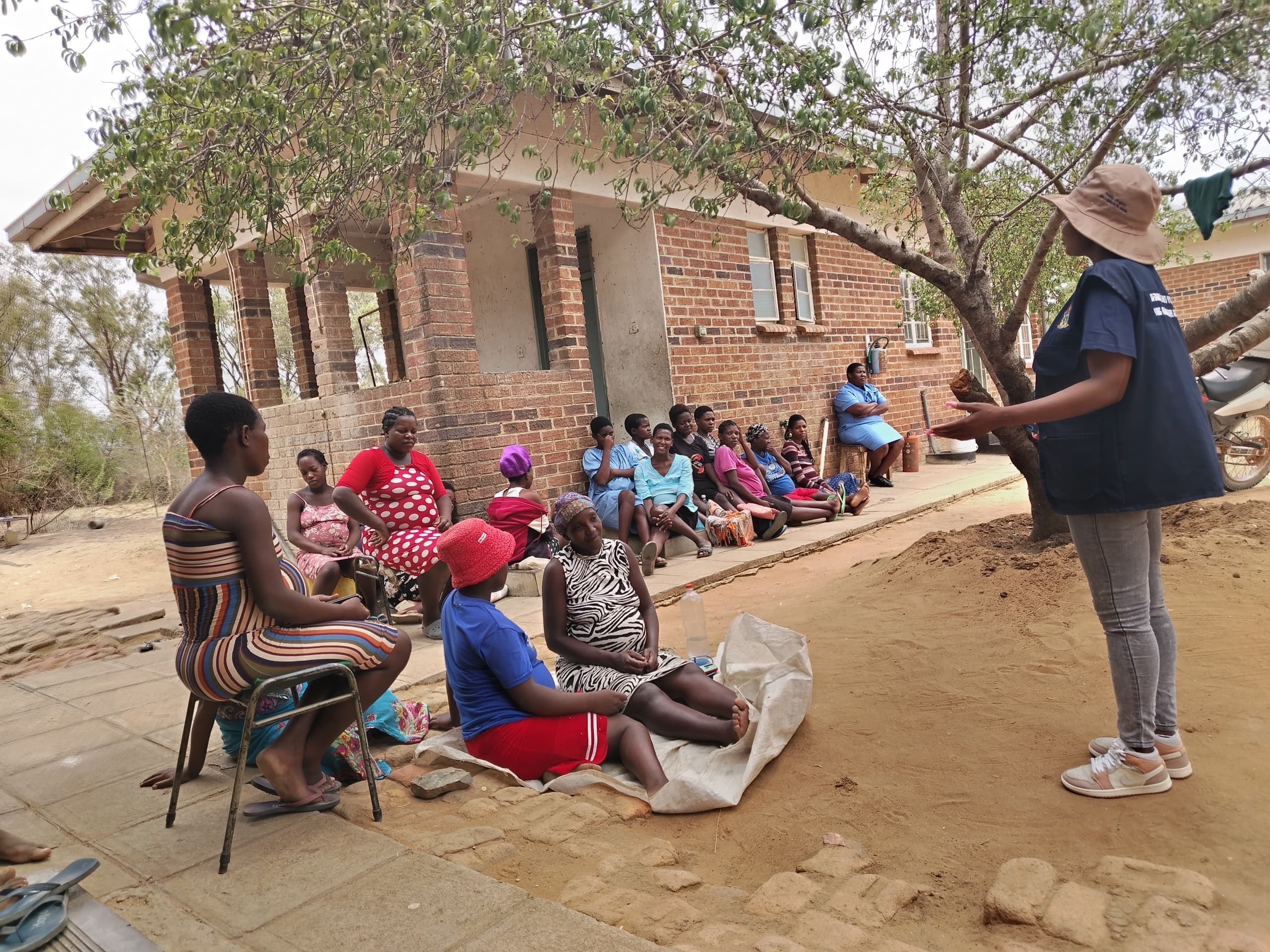 Women gathered at a community sensitization session in Inyathi.